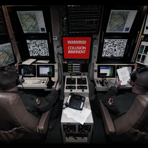 UAS pilot's cockput with multiple screens. One red screen showing: 'Warning! Collision Imminent'